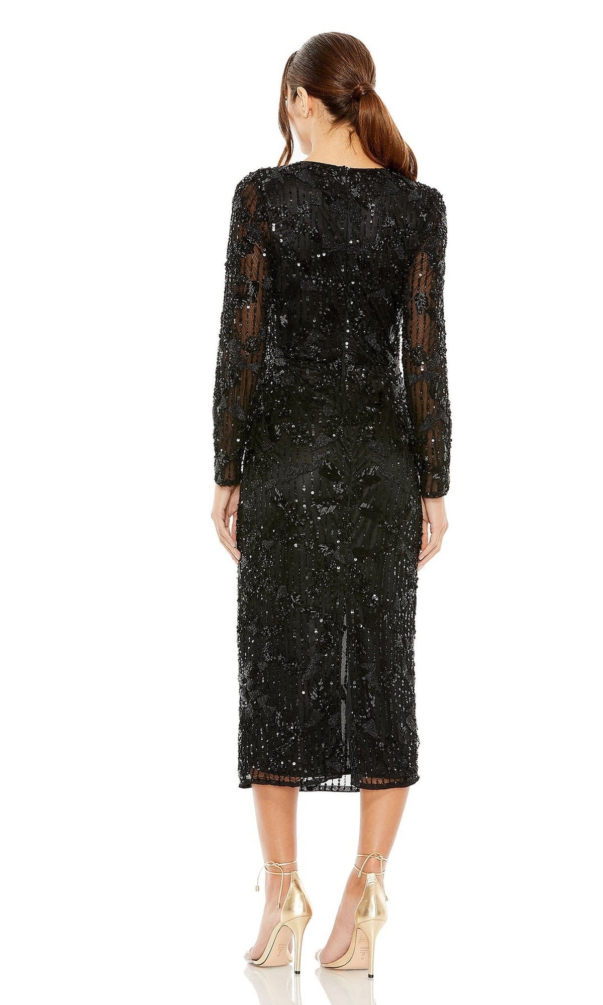 Woman stands with her back to the camera, wearing the Mac Duggal 5988 long sleeve wedding guest dress in chic black sequins with sheer details, elegantly paired with metallic high-heeled shoes.